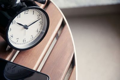 Close-up of alarm clock and mobile phone on the table