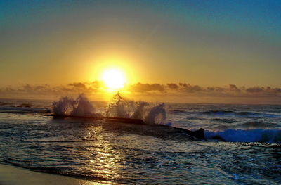Scenic view of sea against clear sky during sunset