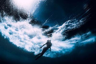 Low section of woman swimming in sea