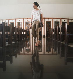 Full length of woman standing on bench