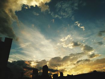 Low angle view of silhouette city against sky during sunset