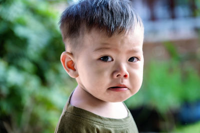 Close up of asian child boy's face with tears. upset crying and mad little toddler boy.