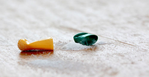 Close-up of broken capsule on table