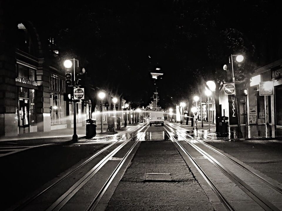 railroad track, transportation, the way forward, illuminated, night, street light, railroad station platform, rail transportation, diminishing perspective, railroad station, public transportation, vanishing point, lighting equipment, empty, built structure, building exterior, city, outdoors, architecture, long