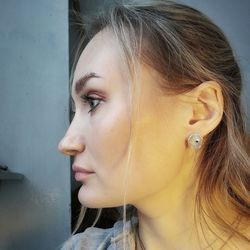 Close-up of young woman looking away against wall