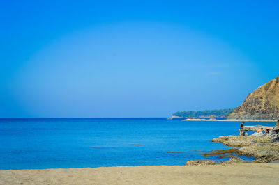 Scenic view of sea against clear blue sky