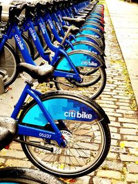 Close-up of bicycle against blue wall