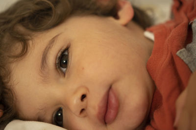 Close-up portrait of cute boy relaxing at home