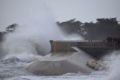 View of waves breaking against the sky