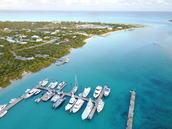 High angle view of yachts moored at harbor by city