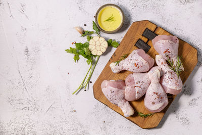 Chicken meat. raw fresh chicken drumsticks with spices on a woden cutting board