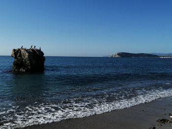 Scenic view of sea against clear sky