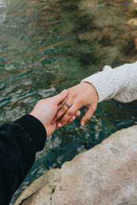 Close-up of couple holding hands