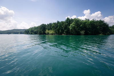 Scenic view of calm lake against cloudy sky