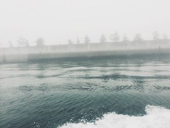 Scenic view of lake against sky during winter