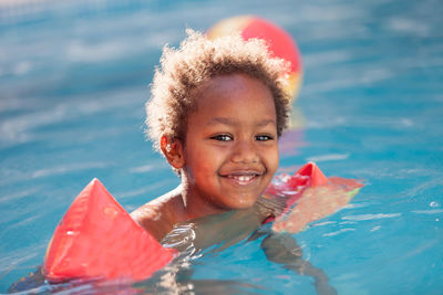 Portrait of smiling boy in swimming pool