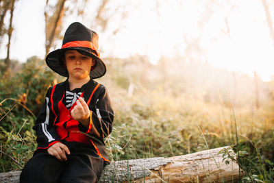 Full length of a boy sitting on land