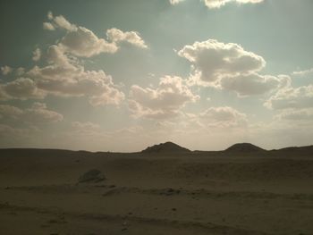 Scenic view of desert against sky during sunset