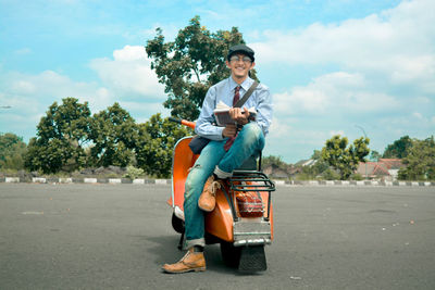 Smiling on an old motorcycle