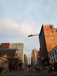 City street and buildings against sky