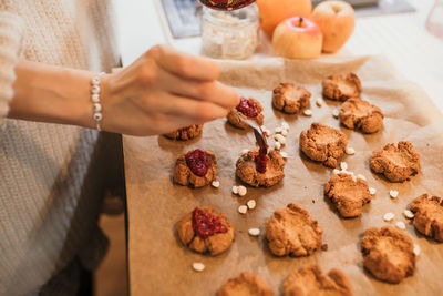 Midsection of woman preparing food on table