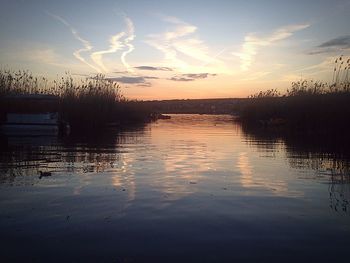 Reflection of clouds in lake at sunset