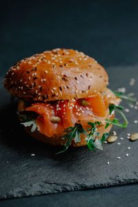 Close-up of burger against black background