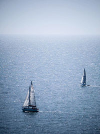 High angle view of sailboats in sea against sky