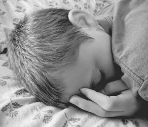 Close-up of baby sleeping on bed