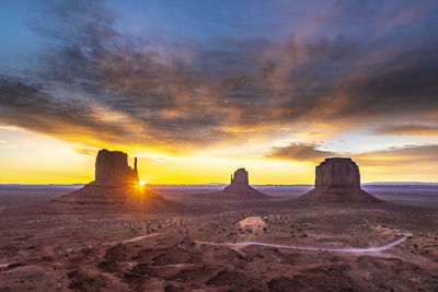 Scenic view of rock formations against sky during sunset