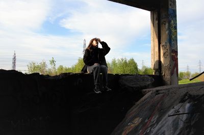 Side view of woman standing on rock