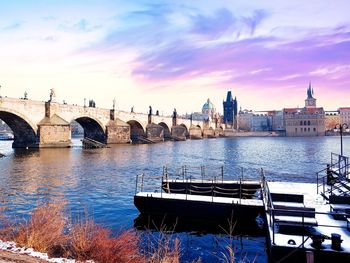 Bridge over river with buildings in background