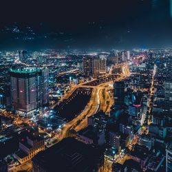 High angle view of illuminated buildings in city at night