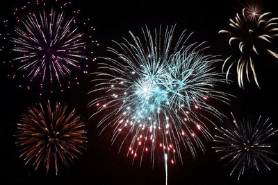 Low angle view of firework display at night