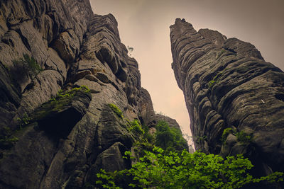 Low angle view of rock formation against sky