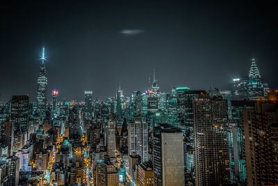 Aerial view of illuminated city at night