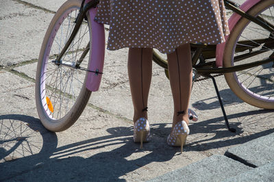 Low section of woman with bicycle