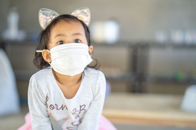 Little girl wearing mask prevent pollution outdoor.