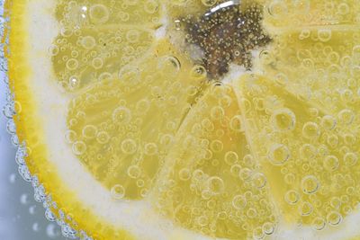 Close-up of a lemon slice in liquid with bubbles. slice of ripe lemon in water. close-up of fresh