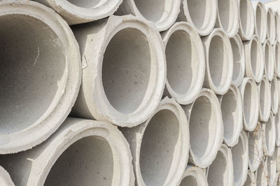 Full frame shot of stacked concrete pipes