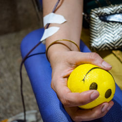 Blood donor at blood donation camp held with a bouncy ball holding in hand at balaji temple