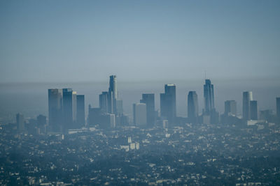 Aerial view of modern buildings in city against sky