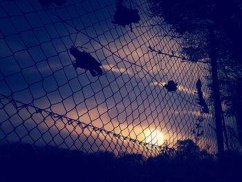 Low angle view of silhouette birds against sky during sunset