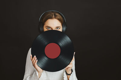 Woman with vinyl record. music passion. listening to music from analog record. retro music party