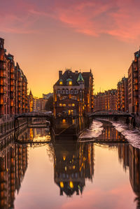 Bridge over canal amidst buildings in city