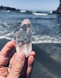 Midsection of person holding ice sea