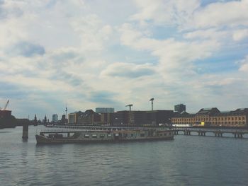 River in city against cloudy sky