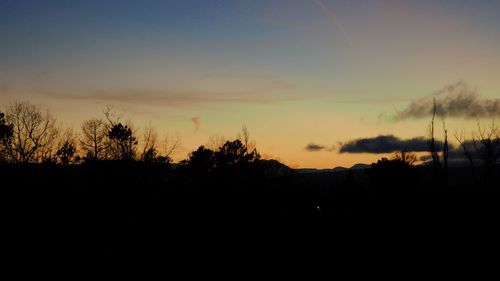 Silhouette landscape against sky during sunset