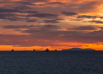 Scenic view of sea against orange sky