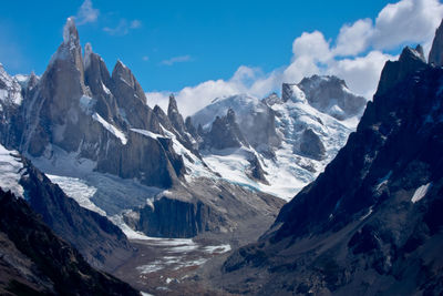 Scenic view of mountains against cloudy sky